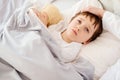 Sick little child with temperature in bed. Royalty Free Stock Photo