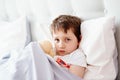 Sick little child with temperature in bed. Royalty Free Stock Photo