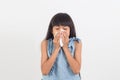 Sick little girl blowing her nose isolated on white Royalty Free Stock Photo