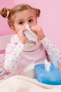 Sick little girl blowing nose