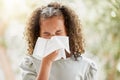 Sick little girl with a flu, blowing her nose and looking uncomfortable. Child suffering with sinus, allergies or covid Royalty Free Stock Photo