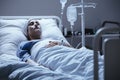 Sick and lonely senior woman with leukemia during chemotherapy i