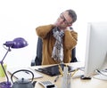 Sick male entrepreneur suffering from sore neck at his desk