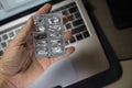 Sick male home office worker taking pills in front of his working space, during his working deadline night. Royalty Free Stock Photo