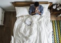 Sick man on bed blowing his nose