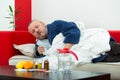 Sick man in bed with drugs and fruit on table Royalty Free Stock Photo