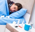 Sick man with flu lying in the bed Royalty Free Stock Photo