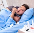 Sick man with flu lying in the bed Royalty Free Stock Photo