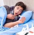 Sick man with flu lying in the bed Royalty Free Stock Photo