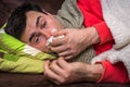 Sick man having flu and blowing her runny nose Royalty Free Stock Photo