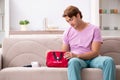 The sick man at home with first aid kit Royalty Free Stock Photo