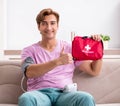 Sick man at home with first aid kit Royalty Free Stock Photo