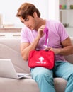 Sick man at home with first aid kit Royalty Free Stock Photo