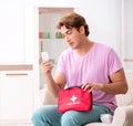 Sick man at home with first aid kit Royalty Free Stock Photo