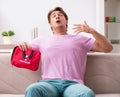 Sick man at home with first aid kit Royalty Free Stock Photo