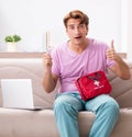 Sick man at home with first aid kit Royalty Free Stock Photo