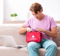 Sick man at home with first aid kit Royalty Free Stock Photo