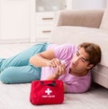 Sick man at home with first aid kit Royalty Free Stock Photo