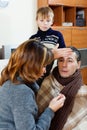 Sick man surrounded by caring wife and son