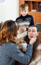 Sick man surrounded by caring wife and son