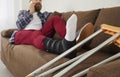 Sick man with trauma relax on sofa talking on phone