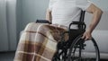 Sick man in wheelchair gathering strength, deciding to move forward, will power