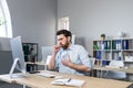 Sick man working in the office, has a bad cough, coughing businessman at the computer Royalty Free Stock Photo
