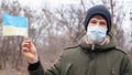 Sick masked man with ukraine flag.coronavirus outbreak in Ukraine. pandemic covid-2019