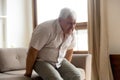 Unhealthy senior man suffer from rheumatism at home