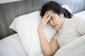 Sick middle aged woman suffering from bad migraine headache stay in bed,migraine attack in the morning,problems of chronic Royalty Free Stock Photo
