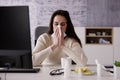 Sick Office Employee Sneezing At Work