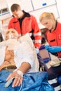 Sick patient with paramedic in ambulance treatment