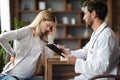 Sick Pregnant Woman Feeling Unwell During Meeting With Her Doctor In Clinic Royalty Free Stock Photo