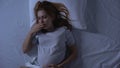 Sick pregnant woman suffering from nausea lying bed, toxicosis symptom, health