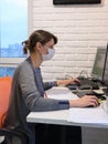 A sick quarantined girl works at a computer