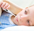 Sick and sad kid in bed Royalty Free Stock Photo