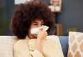 Sick, sad and woman with covid blowing nose on the sofa with a blanket in the lounge of a house. Burnout, virus and