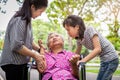 Sick senior grandmother in wheelchair with epileptic seizures in outdoor,elderly patient convulsions suffering from illness with Royalty Free Stock Photo