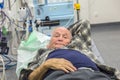 Sick senior lying in an emergency room