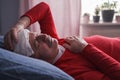 A sick male sleeping with wet towel on his forehead to reduce high high fever Royalty Free Stock Photo