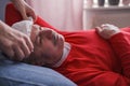 A sick male sleeping with wet towel on his forehead to reduce high high fever Royalty Free Stock Photo