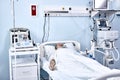 Sick Senior Patient Rests on Bed, Man Sleeping in Modern Hospital Ward. Royalty Free Stock Photo