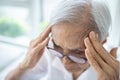 Sick senior woman with headache,pain in the head,brain system problems,chronic illness,elderly has dizziness,symptoms of benign
