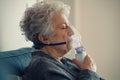 Sick senior woman making inhalation with nebulizer Royalty Free Stock Photo