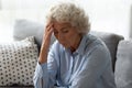 Sick senior woman touch head suffering from dizziness at home Royalty Free Stock Photo