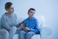 Sick son sitting on sofa Royalty Free Stock Photo