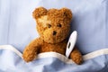 Sick teddy bear on hospital bed Royalty Free Stock Photo