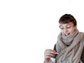 Sick teen in grey knitted scarf with thermometer on white background Royalty Free Stock Photo