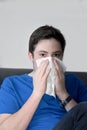 Sick teenage boy blowing his nose Royalty Free Stock Photo