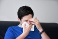 Sick teenage boy blowing his nose Royalty Free Stock Photo